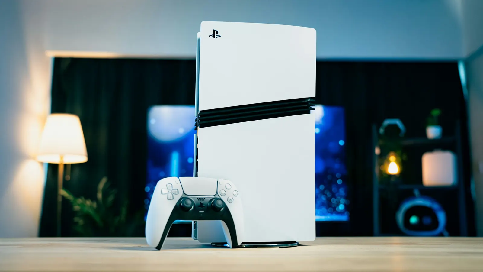 A PS5 Slim with a DualSense controller on a wooden table
